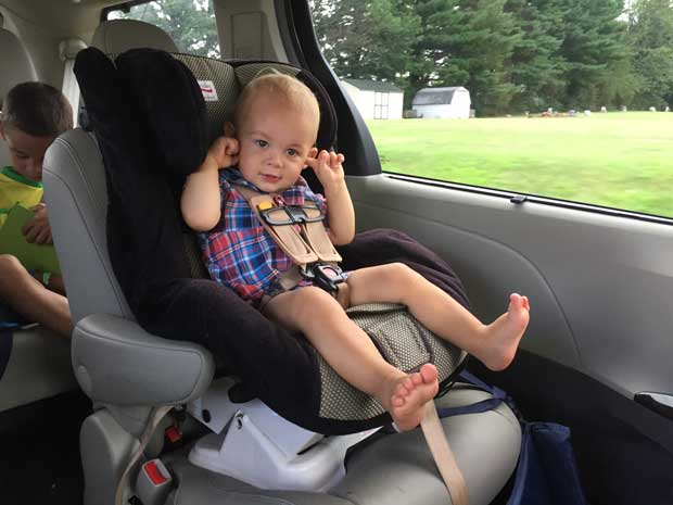 a happy baby in the infant seat of Toyota Sienna 2016
