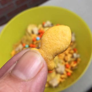 Holding goldfish over snack bowl