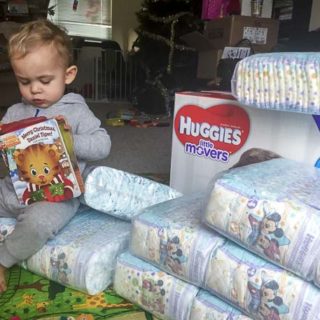 Who is on the diaper duty - child reads book in a pile of diapers