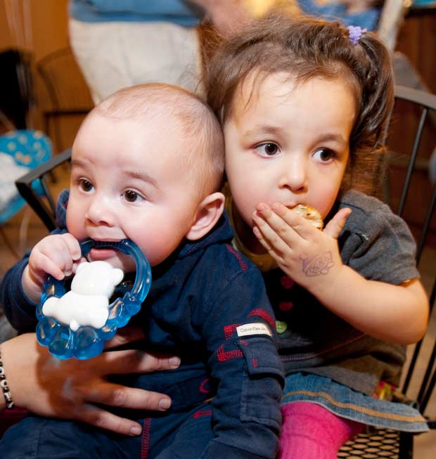 Toddler girl and baby boy are eating