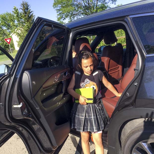 Girl stands next to Mazda