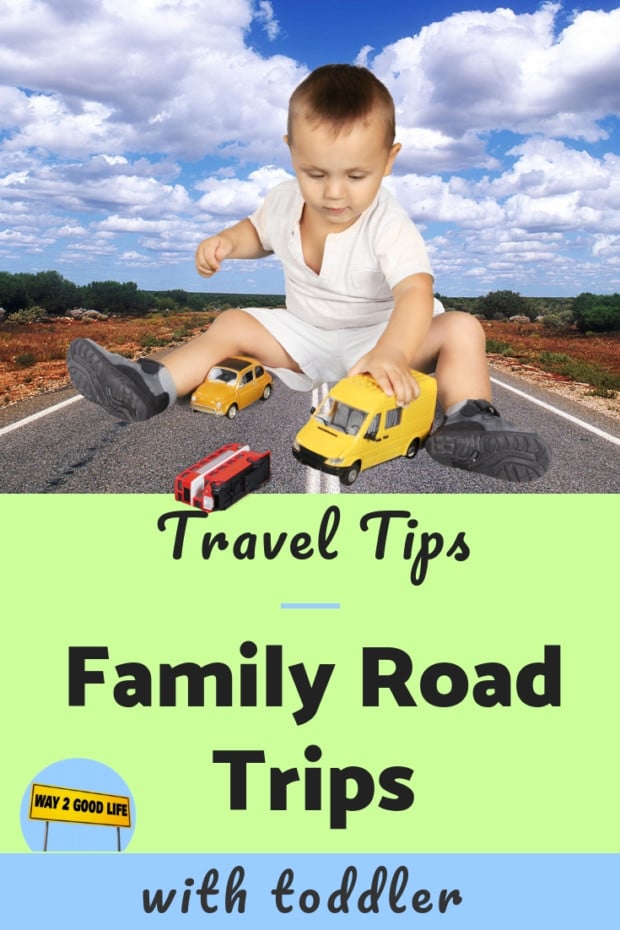 A boy sitting on the road playing with toy cars
