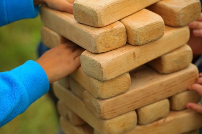 A boy plays giant jenga