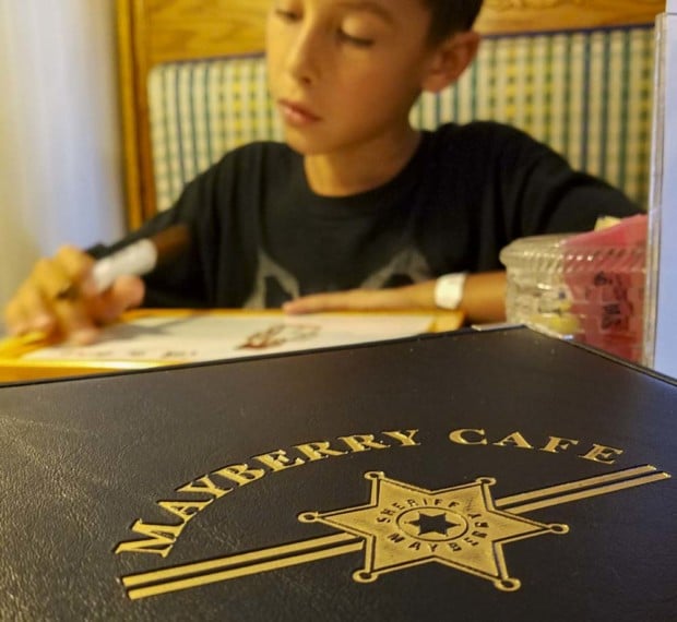 Mayberry Cafe menu close up with boy
